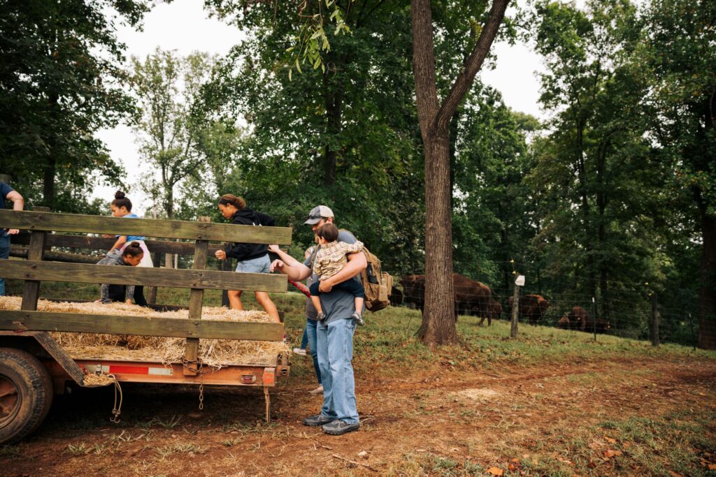 children getting on hay ride at farm tour