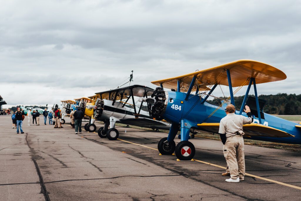 people looking at airplanes