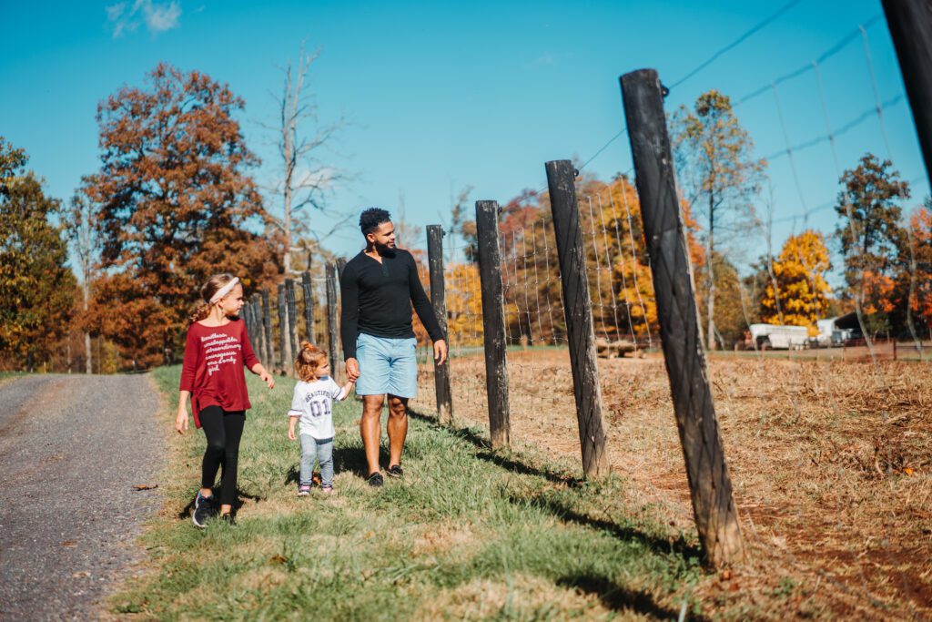 man and two kids walking