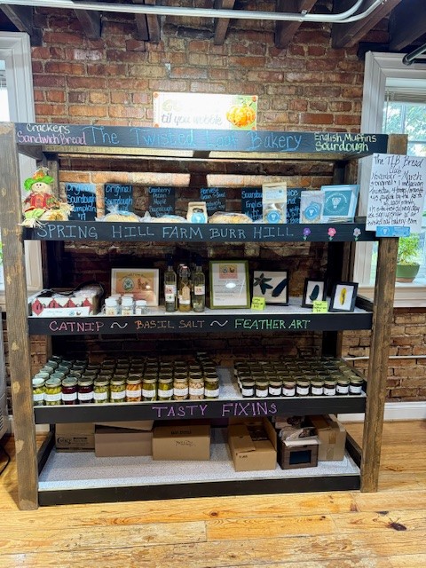 shelf with jams, bread, and jarred foods.