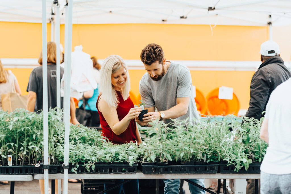 male and female looking at plants