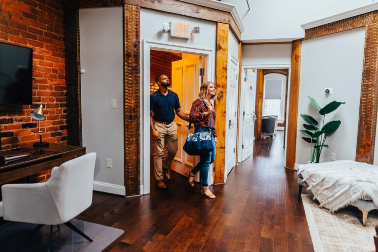 Man and woman walking into a room