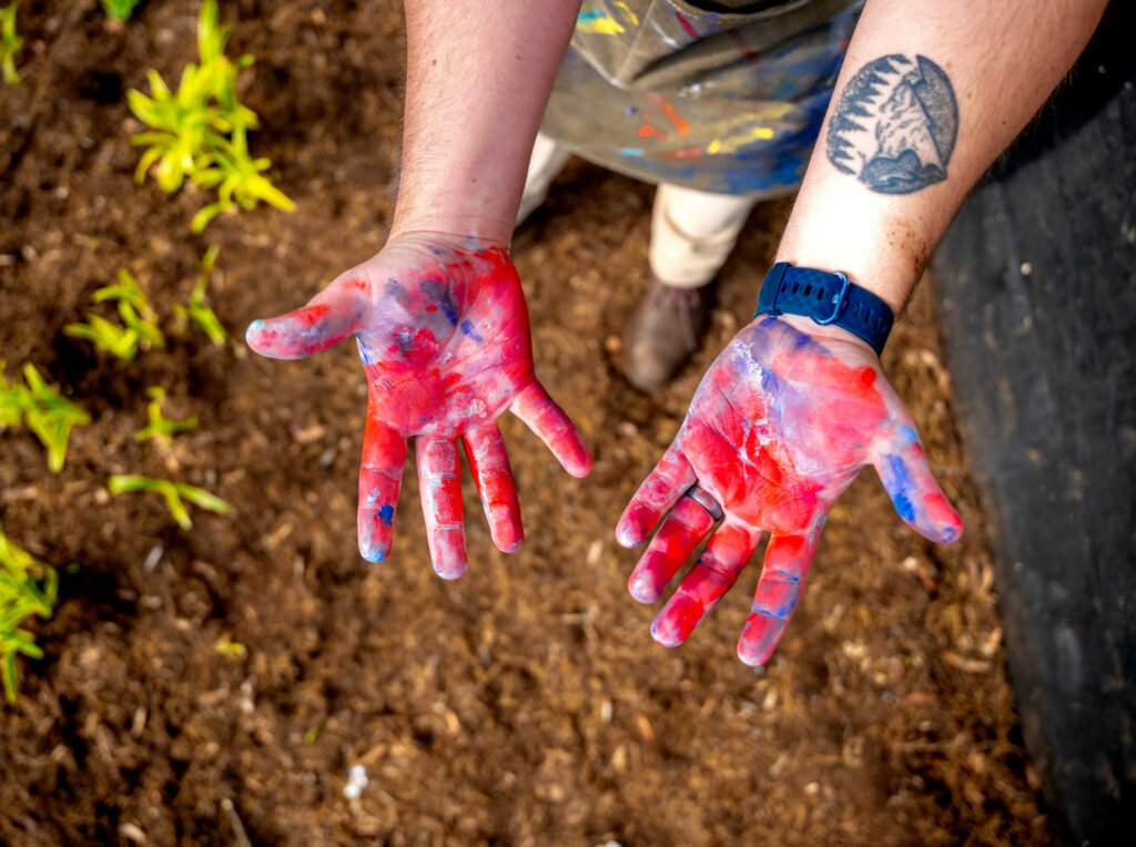 two hands with paint on them