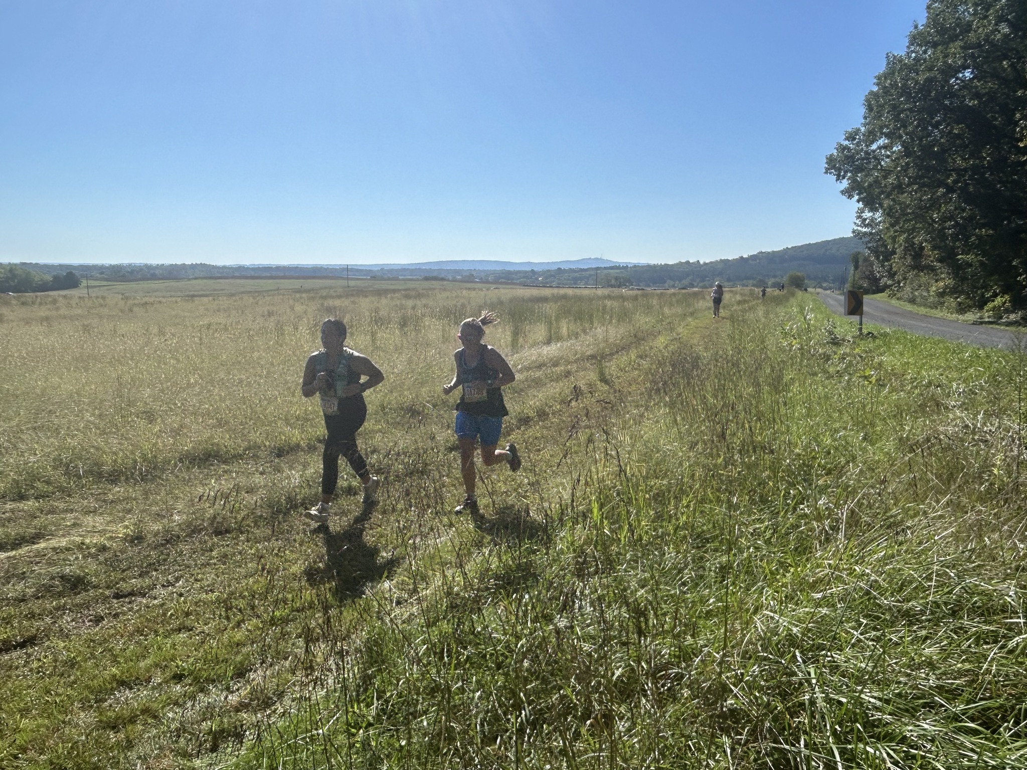 two people running in a field