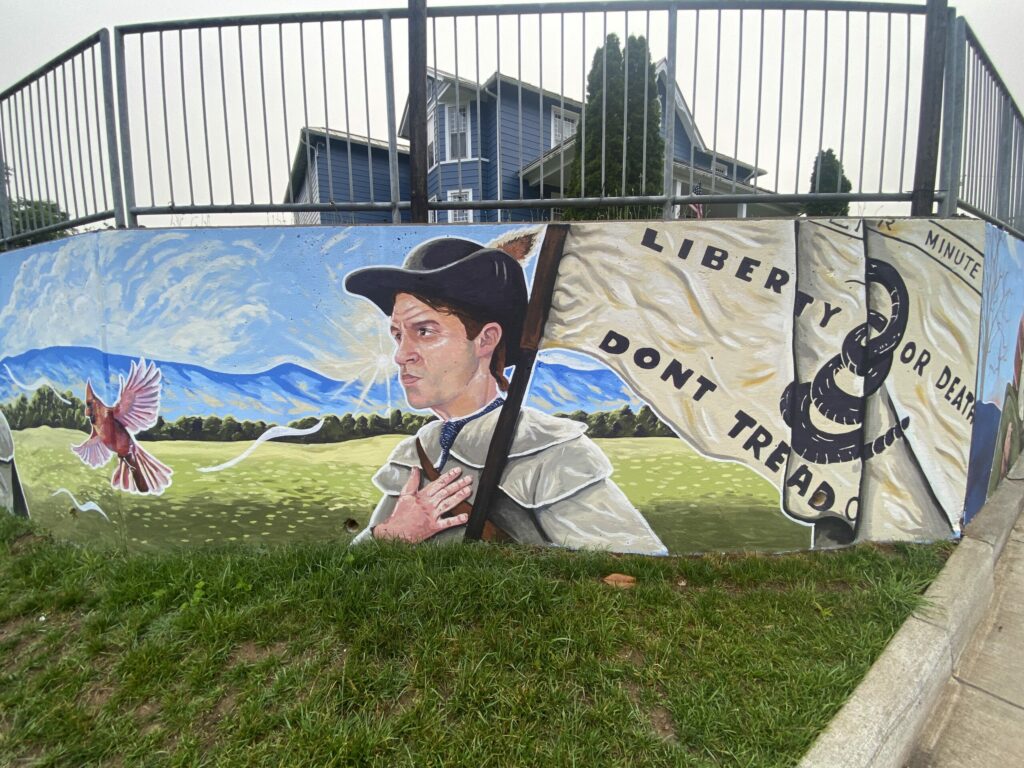 mural of a minuteman holding a Culpeper Minutemen flag