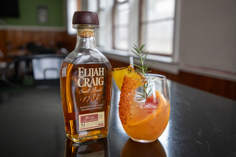 bottle of Elijah Craig with a decorative orange drink