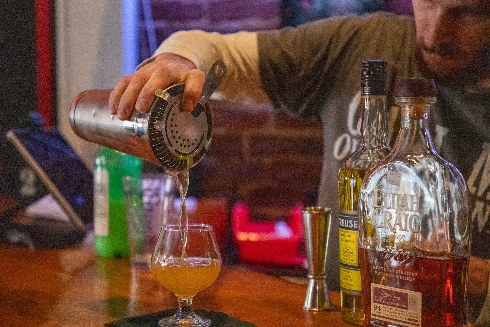 man pouring a mixed drink