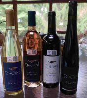 4 Ducard wine bottles on a table