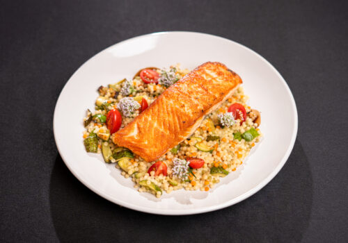 Salmon on a bead of couscous and vegetables Image