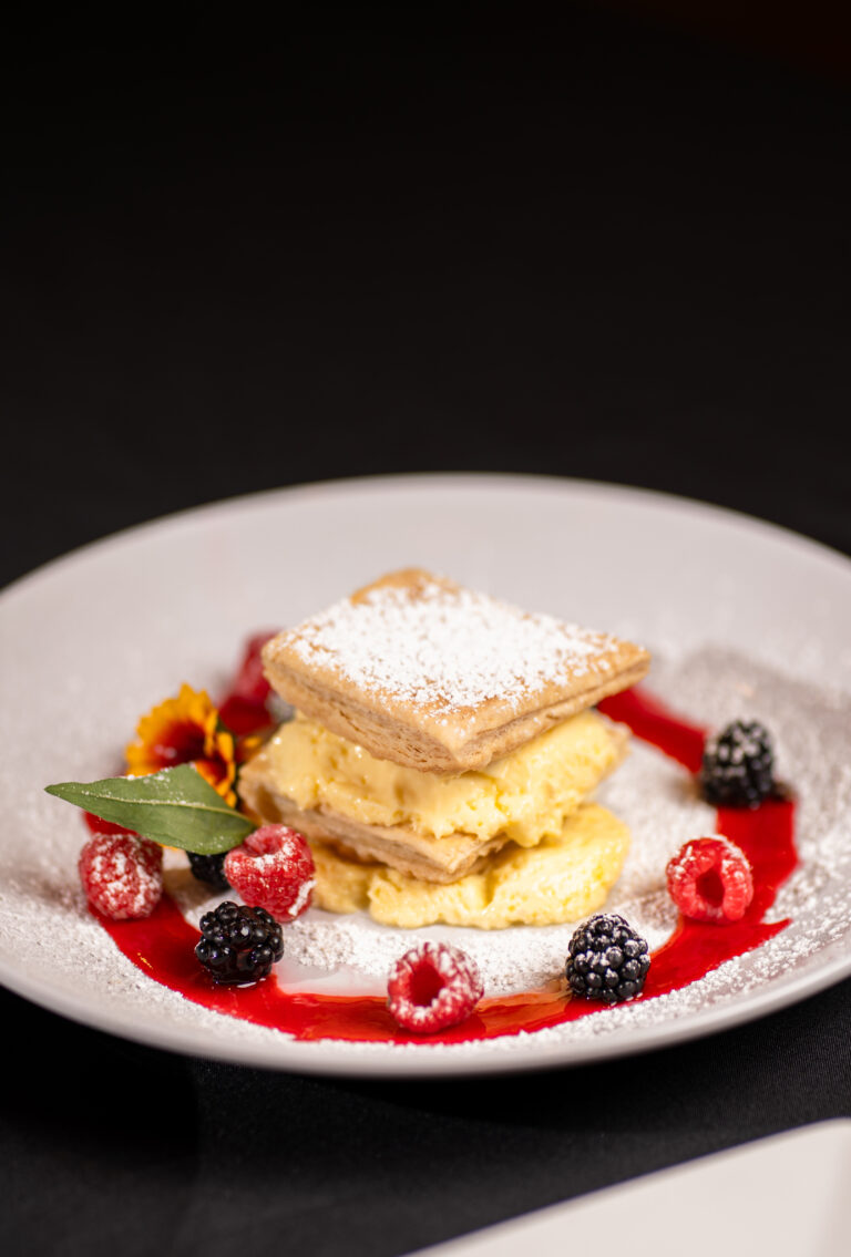 pastry with berries and red syrup