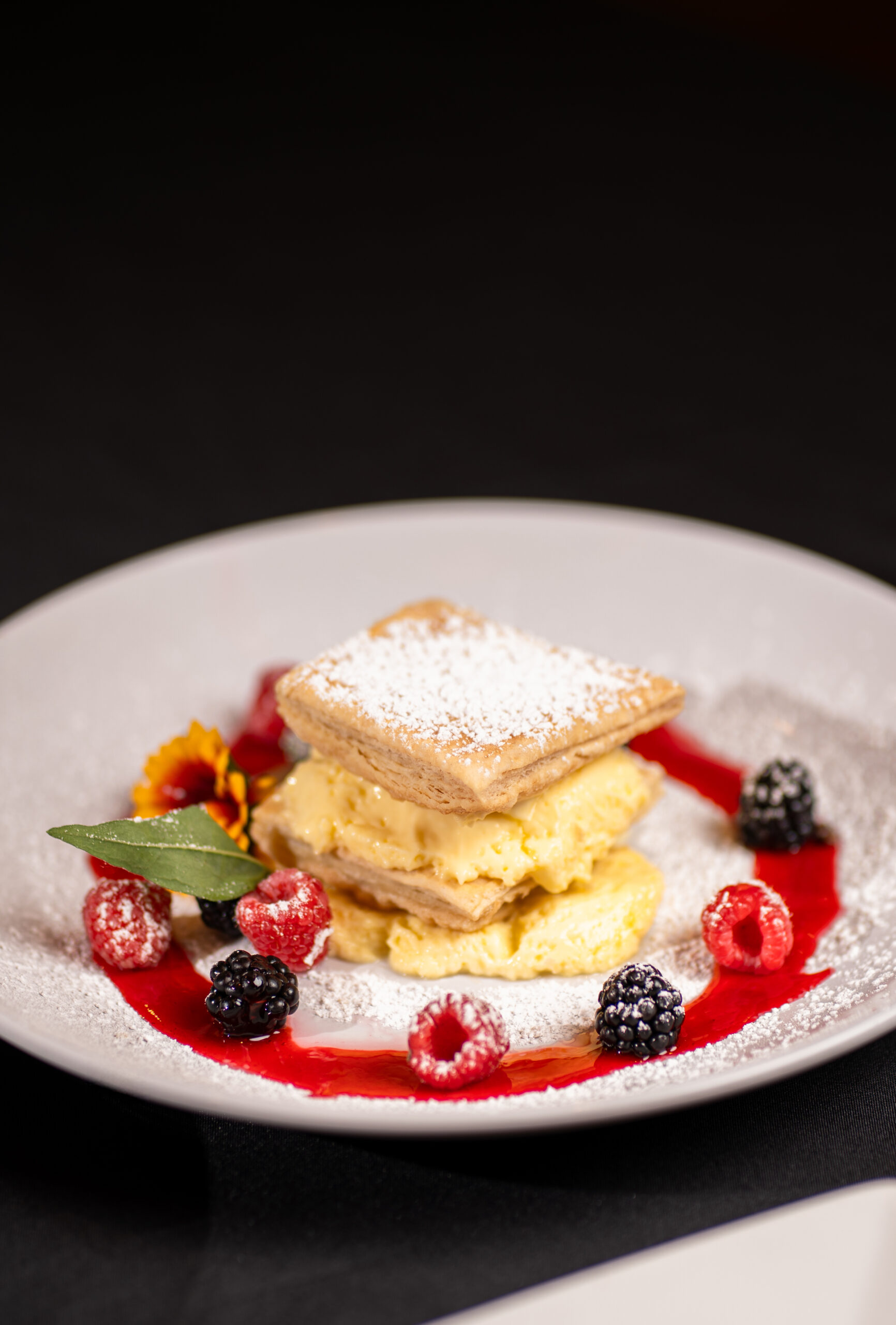 pastry with berries and red syrup